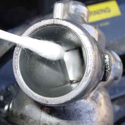 Saab 900s | Use cotton swab to clean the gate. It may help to use at the same time a small screwdriver to turn the gate and clean it all around. (Sorry, not able to take the picture!) Update: Don't try to force open the gate, il will damage the IAC gate. I managed to clean it in closing the gate as much as I can without forcing anything