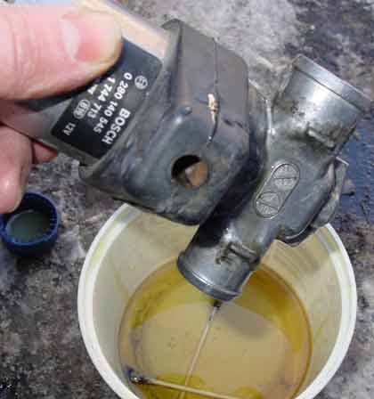 Saab 900s | Turn the IAC upside down and let the oil drip. Don't wipe clean the interior, the oil is there as a lubricant. Don't worry, it is not harmfull for the IAC. Wipe clean the exterior.